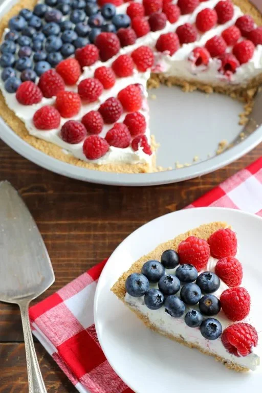 An image of American Flag Fruit Pizza topped with strawberries and blueberries.