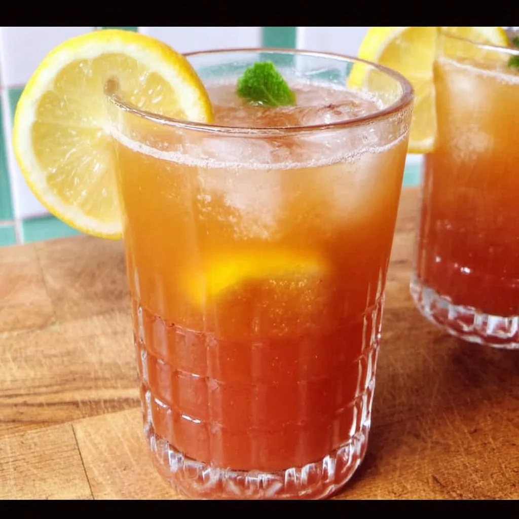 Glass of refreshing non-alcoholic summer punch with colorful fruits