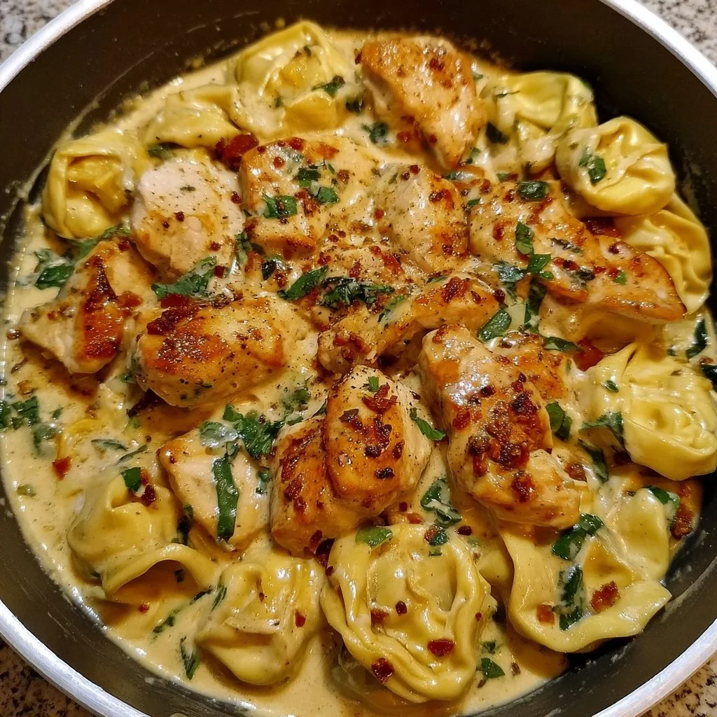 One pot creamy parmesan chicken tortellini served with parsley garnish