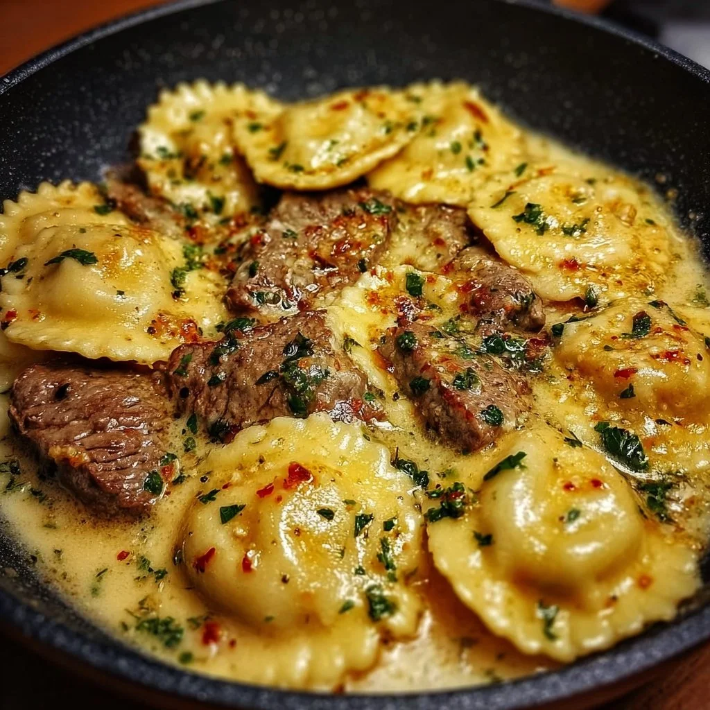 Delicious garlic butter steak served with cheese ravioli in a skillet