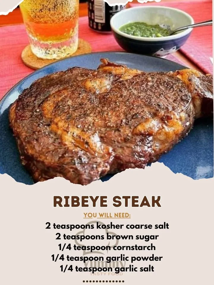 Perfectly cooked ribeye steak on a grill with seasoning and herbs